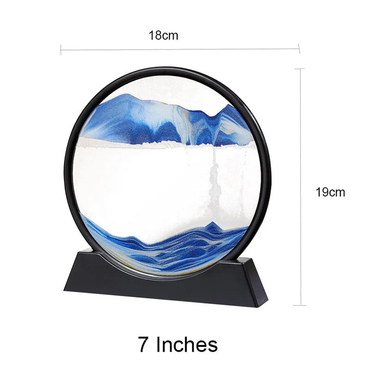 Sand Frame with black circular acrylic frame containing blue and white sand art creating mountain and wave patterns